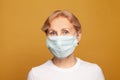 Attractive senior woman in protective medical mask, studio shot Royalty Free Stock Photo