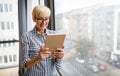 Attractive senior woman using a tablet computer relaxing at home Royalty Free Stock Photo