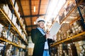 Senior woman warehouse manager or supervisor with tablet, working. Royalty Free Stock Photo