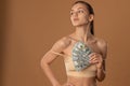 Attractive sensual girl in beige bra holds US dollar bills in her hand and looking at the left side Royalty Free Stock Photo