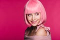 Attractive sensual girl in pink wig biting lip, isolated