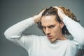 Attractive sensual guy poses in white t-shirt. Man with confident face and brutal style. Copyspace. In casual light t Royalty Free Stock Photo