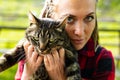 Attractive serious young woman holding her cat Royalty Free Stock Photo