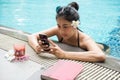 woman play smartphone at pool