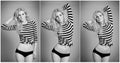 Attractive blonde in black and white tight fit dress and bikini posing provocatively . Portrait of sensual woman Royalty Free Stock Photo