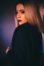Attractive blonde women wear black bra and jacket. Evening make up black smokey eyes and red lipstick. Royalty Free Stock Photo