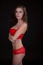 Attractive sexy woman with a beautiful body posing in Lacy red underwear Royalty Free Stock Photo