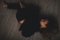 Attractive woman lies on the floor. She looks sensuality. Hot girl wears total black look.