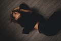 Attractive woman lies on the floor. She looks sensuality. Hot girl wears total black look.