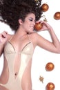 Attractive woman with shine gold bikini lying, Christmas balls around her Royalty Free Stock Photo