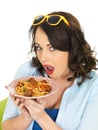 Attractive Shocked Young Woman Holding a Plate of Spaghetti Meatballs Royalty Free Stock Photo