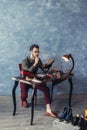 Attractive shoeshine boy reparing shoes indoors