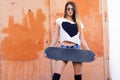 Attractive skater girl holding skateboard in her hands Royalty Free Stock Photo