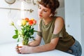 Portrait girl with bouquet of multi-colored roses at home