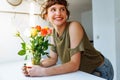 Portrait girl with bouquet of multi-colored roses at home