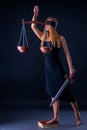 Attractive slim girl with Libra and Sword as a Themis Godness. Royalty Free Stock Photo