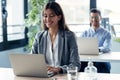 Attractive smart business team working while doing a video call with diverse colleagues on online briefing with laptop in the Royalty Free Stock Photo