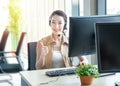 Attractive and smile young asian customer servicer woman wearing headset in modern creative meeting working office sit at computer Royalty Free Stock Photo