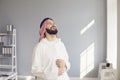 Attractive smiling arab man laughing rejoices standing in a modern office