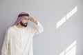 Attractive smiling arab man looking on a gray background