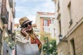 Attractive smiling blonde girl speaks on her mobile phone while walking with shopping bags Royalty Free Stock Photo