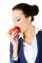 Attractive smiling businesswoman holding red apple Royalty Free Stock Photo