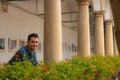 Attractive smiling cute guy young adult male portrait in shirt looking at camera in palace balcony Royalty Free Stock Photo