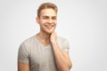 An attractive smiling cute young blond man smiles merrily and looks at the camera. close-up portrait on isolated background Royalty Free Stock Photo