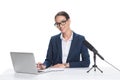 attractive smiling female newscaster sitting at table with laptop, notepad and microphone,