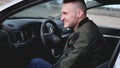 Attractive smiling young man in a car Royalty Free Stock Photo