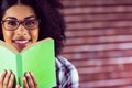 Attractive smiling hipster holding book Royalty Free Stock Photo