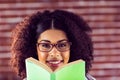 Attractive smiling hipster holding book Royalty Free Stock Photo