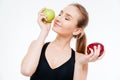 Attractive smiling woman athlete posing with red and green apples Royalty Free Stock Photo