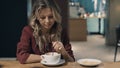 Attractive smiling woman in cafe dreaming and waiting for a meeting Royalty Free Stock Photo