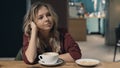 Attractive smiling woman in cafe dreaming and waiting for a meeting Royalty Free Stock Photo