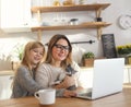 Attractive smiling woman working with little adorable daughter and kitten Royalty Free Stock Photo