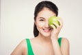 Attractive smiling young asian woman eating green apple isolated Royalty Free Stock Photo