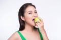 Attractive smiling young asian woman eating green apple isolated Royalty Free Stock Photo