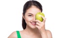 Attractive smiling young asian woman eating green apple isolated Royalty Free Stock Photo