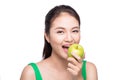 Attractive smiling young asian woman eating green apple isolated Royalty Free Stock Photo