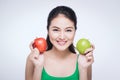 Attractive smiling young asian woman holding green apple isolated over white background Royalty Free Stock Photo