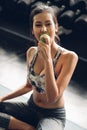 Attractive smiling young asian woman holding  green apple to eat. Healthy concept Royalty Free Stock Photo