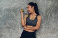 Attractive smiling young asian woman holding  green apple to eat. Healthy concept Royalty Free Stock Photo