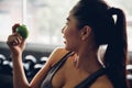 Attractive smiling young asian woman holding  green apple to eat. Healthy concept Royalty Free Stock Photo