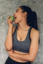 Attractive smiling young asian woman holding  green apple to eat. Healthy concept Royalty Free Stock Photo