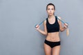 Attractive sport girl holding jumping rope and looking at camera Royalty Free Stock Photo