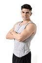 Attractive sport man with big strong athletic body posing with folded arms looking cool smiling happy