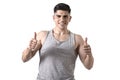 Attractive sport man with big and strong athletic body smiling happy wearing singlet giving thumb up