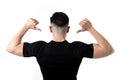 Attractive sport man pointing on his black t-shirt with copy sp Royalty Free Stock Photo