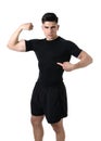 Attractive sport man pointing on his black t-shirt with copy space for adding gym fitness health club logo Royalty Free Stock Photo